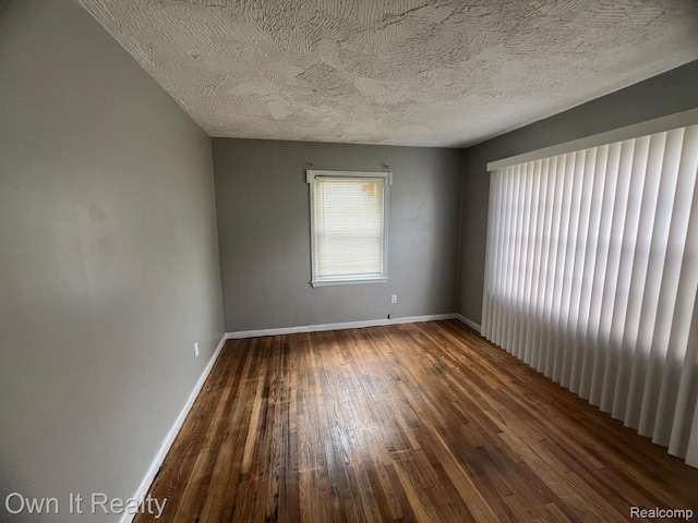 8620 Fielding St, Detroit, MI 48228 - spare room with hardwood / wood-style floors and a textured ceiling