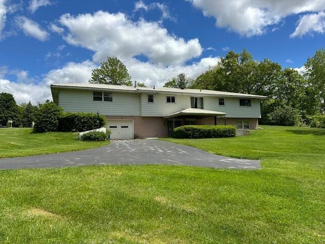 395 Hyannis Hills Dr, Tekonsha, MI 49092 - view of front of property featuring a garage, driveway, and a front yard