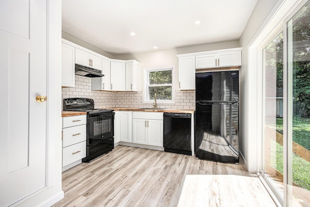 556 Union St, Niles, MI 49120 - kitchen featuring butcher block counters, black appliances, under cabinet range hood, tasteful backsplash, and recessed lighting