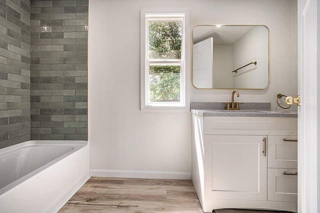 556 Union St, Niles, MI 49120 - bathroom with vanity, wood finished floors, plenty of natural light, and bathing tub / shower combination