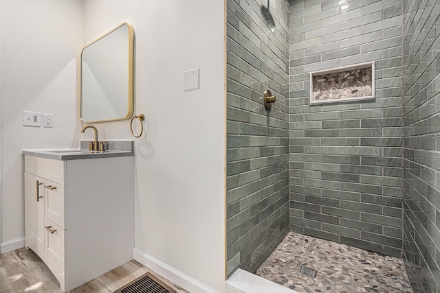 556 Union St, Niles, MI 49120 - bathroom with vanity, wood finished floors, and a tile shower