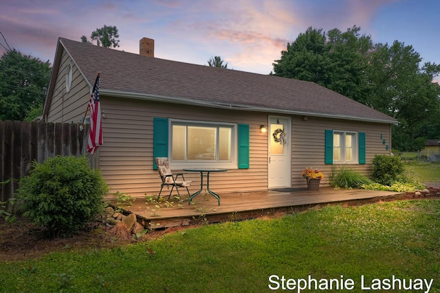 169 S Linda St NE, Cedar Springs, MI 49319 - view of front of home with a deck, a chimney, and a shingled roof