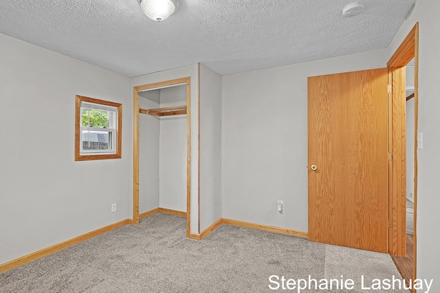 169 S Linda St NE, Cedar Springs, MI 49319 - unfurnished bedroom with carpet floors, a textured ceiling, and a closet