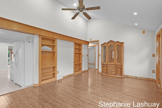 169 S Linda St NE, Cedar Springs, MI 49319 - unfurnished bedroom with white refrigerator with ice dispenser, high vaulted ceiling, wood finished floors, recessed lighting, and a ceiling fan