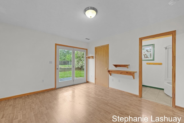 169 S Linda St NE, Cedar Springs, MI 49319 - unfurnished living room featuring light wood-type flooring and baseboards