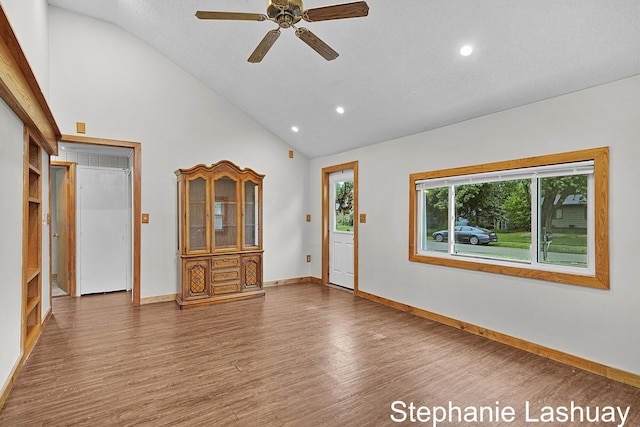 169 S Linda St NE, Cedar Springs, MI 49319 - unfurnished living room featuring wood finished floors, ceiling fan, high vaulted ceiling, and recessed lighting
