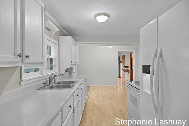 169 S Linda St NE, Cedar Springs, MI 49319 - kitchen with white refrigerator with ice dispenser, range, white cabinets, light wood-style floors, and light countertops