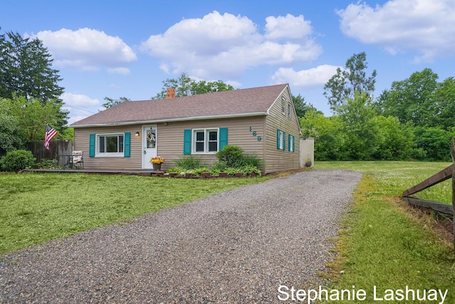 169 S Linda St NE, Cedar Springs, MI 49319 - view of front of house featuring a chimney, driveway, and roof with shingles