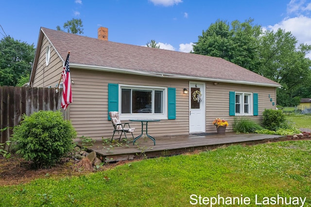 169 S Linda St NE, Cedar Springs, MI 49319 - bungalow-style house with a chimney, a deck, and a shingled roof