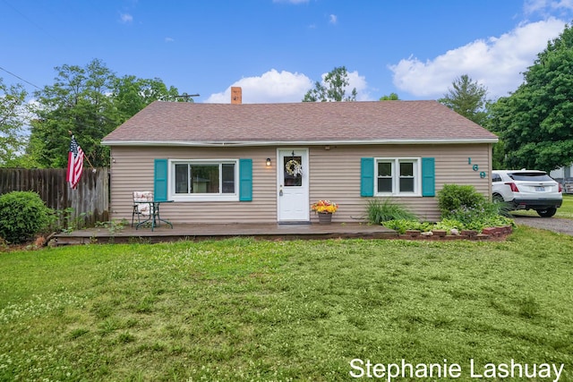 169 S Linda St NE, Cedar Springs, MI 49319 - view of front of house featuring a chimney, a wooden deck, and roof with shingles
