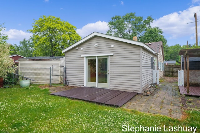 169 S Linda St NE, Cedar Springs, MI 49319 - rear view of house featuring a wooden deck and a fenced backyard
