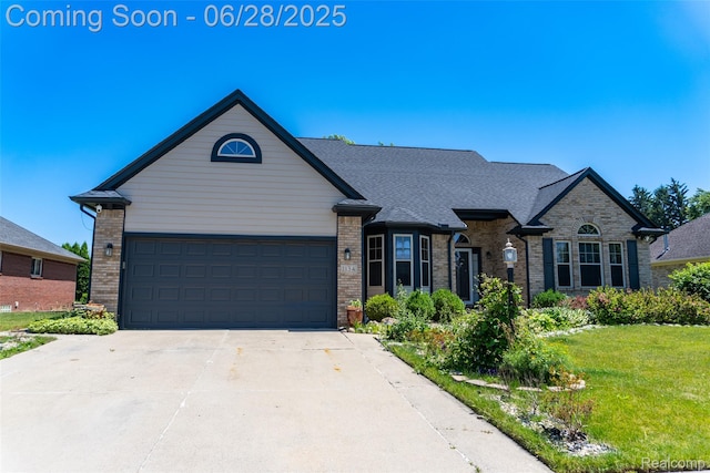 1134 Williamson Cir, Pontiac, MI 48340 - view of front of home with brick siding, concrete driveway, a front lawn, and a garage