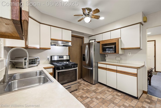 3123 W Utica Rd, Shelby Twp, MI 48317 - kitchen featuring appliances with stainless steel finishes, under cabinet range hood, light countertops, white cabinetry, and recessed lighting