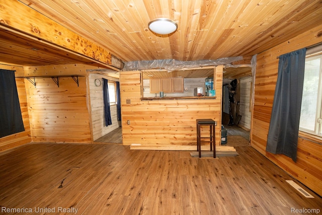 106 Devonshire Dr, Prudenville, MI 48651 - unfurnished living room with wooden walls, wooden ceiling, and hardwood / wood-style flooring