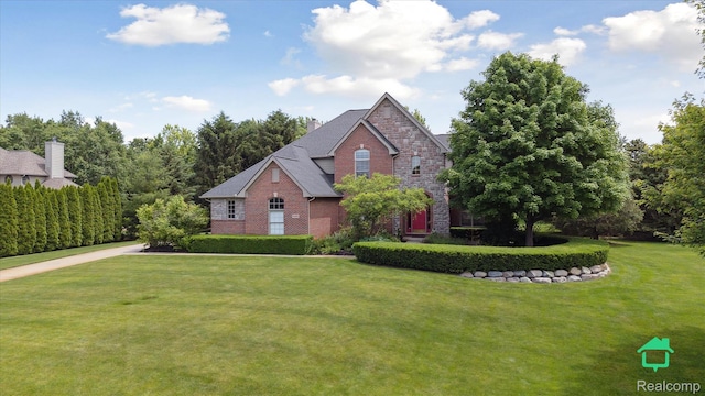 6345 Brookview Dr, Saline, MI 48176 - view of front of house featuring brick siding and a front lawn