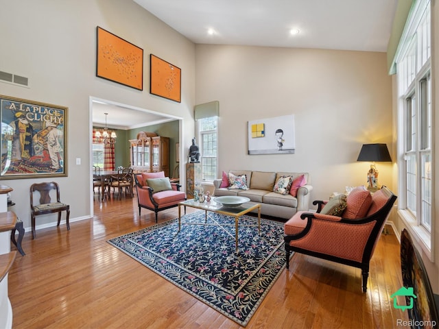 6345 Brookview Dr, Saline, MI 48176 - living room with high vaulted ceiling, wood finished floors, a chandelier, and recessed lighting