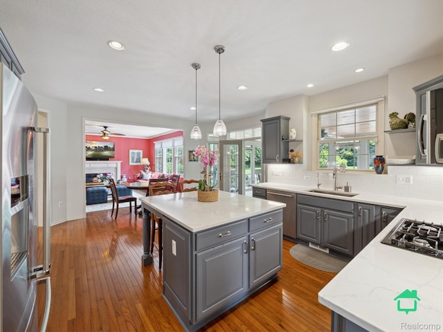 6345 Brookview Dr, Saline, MI 48176 - kitchen featuring appliances with stainless steel finishes, gray cabinetry, open shelves, backsplash, and recessed lighting