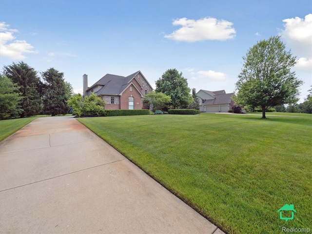 6345 Brookview Dr, Saline, MI 48176 - view of front of home with a front yard, brick siding, and a chimney