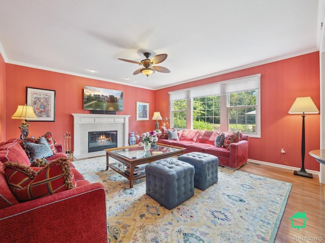 6345 Brookview Dr, Saline, MI 48176 - living area featuring crown molding, ceiling fan, wood finished floors, and a tiled fireplace