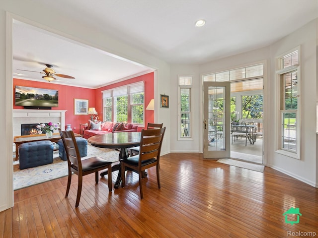 6345 Brookview Dr, Saline, MI 48176 - dining room featuring wood-type flooring, a tiled fireplace, ceiling fan, and recessed lighting