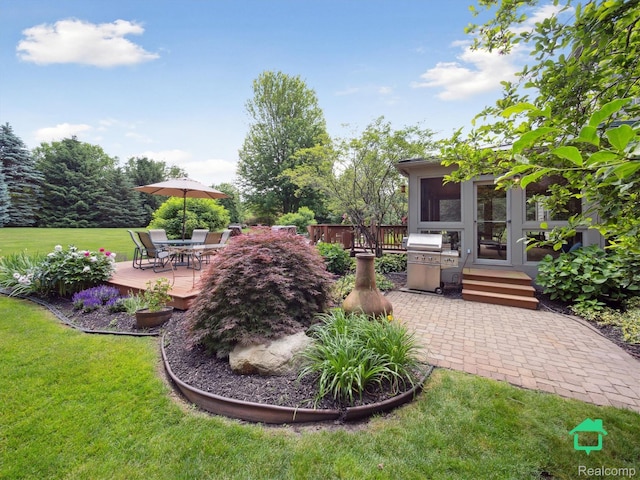 6345 Brookview Dr, Saline, MI 48176 - view of green lawn with a deck and outdoor dining area