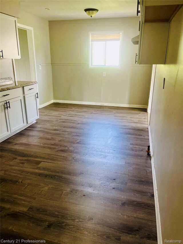 14463 Leonard Ave, Warren, MI 48089 - unfurnished dining area with dark wood-style floors and baseboards
