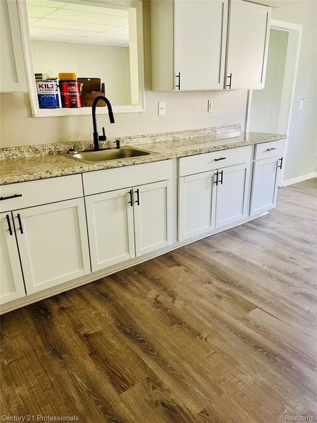 14463 Leonard Ave, Warren, MI 48089 - kitchen featuring wood finished floors, white cabinets, and light stone counters