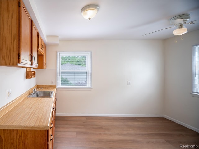 25457 Andover Dr, Dearborn Heights, MI 48125 - kitchen with wood finished floors, light countertops, brown cabinets, and ceiling fan