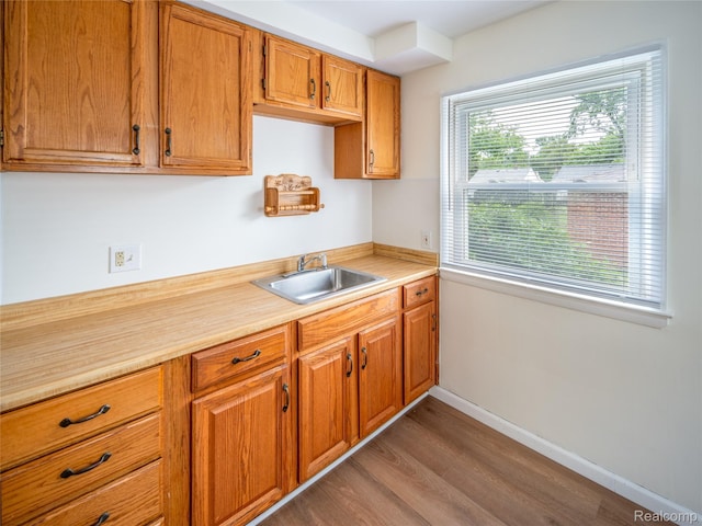 25457 Andover Dr, Dearborn Heights, MI 48125 - kitchen featuring light countertops, wood finished floors, and brown cabinetry