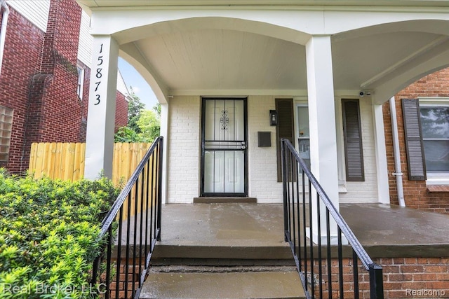 15873 Kentfield St, Dearborn, MI 48223 - entrance to property with brick siding, a porch, and a security system
