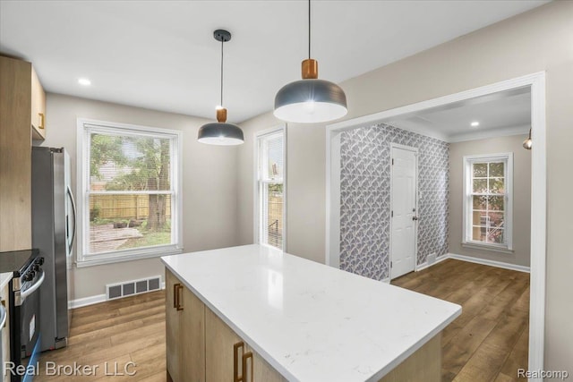 15873 Kentfield St, Dearborn, MI 48223 - kitchen featuring appliances with stainless steel finishes, wood finished floors, a center island, decorative light fixtures, and recessed lighting