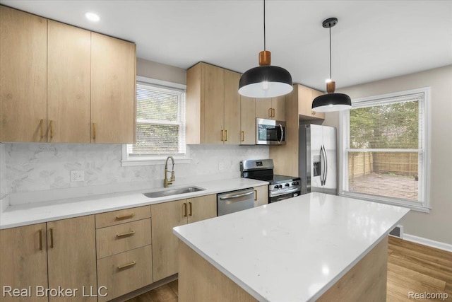 15873 Kentfield St, Dearborn, MI 48223 - kitchen featuring stainless steel appliances, light brown cabinetry, light countertops, and backsplash