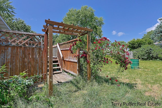 4651 Remembrance Rd NW, Grand Rapids, MI 49534 - view of green lawn featuring a wooden deck, a pergola, and stairway