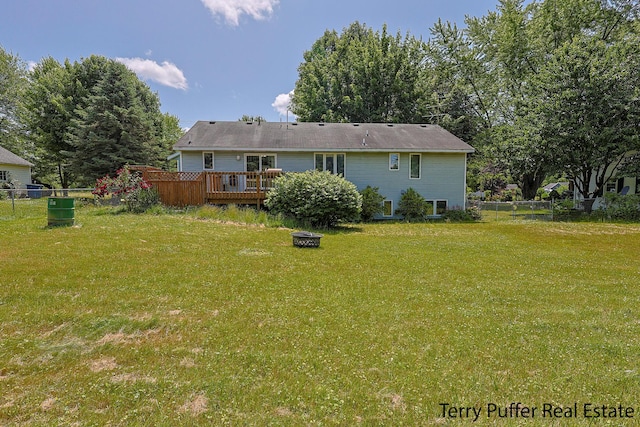 4651 Remembrance Rd NW, Grand Rapids, MI 49534 - back of house with a wooden deck and an outdoor fire pit