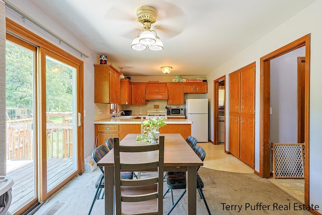 4651 Remembrance Rd NW, Grand Rapids, MI 49534 - kitchen featuring freestanding refrigerator, stainless steel microwave, light countertops, ceiling fan, and stove