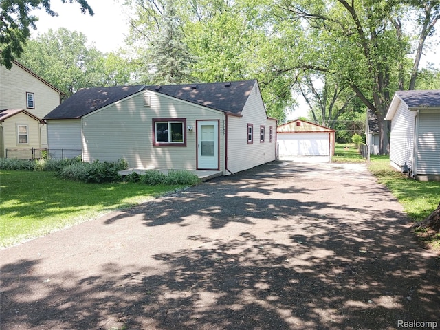 11132 Cape Cod St, Taylor, MI 48180 - view of front of property with a garage, an outbuilding, and a shingled roof