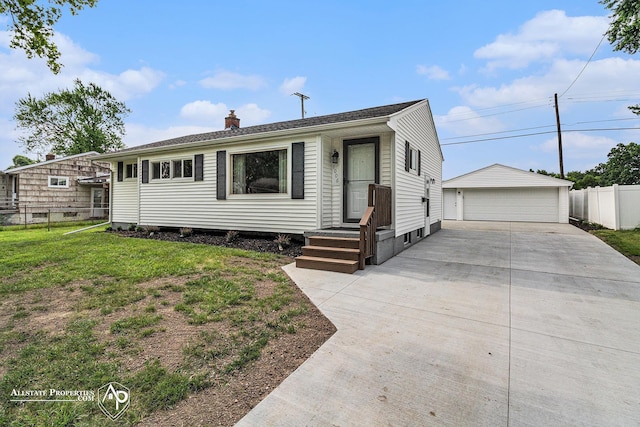 1006 Southlawn Ave, Flint, MI 48507 - view of front of house with a chimney, a detached garage, and an outbuilding
