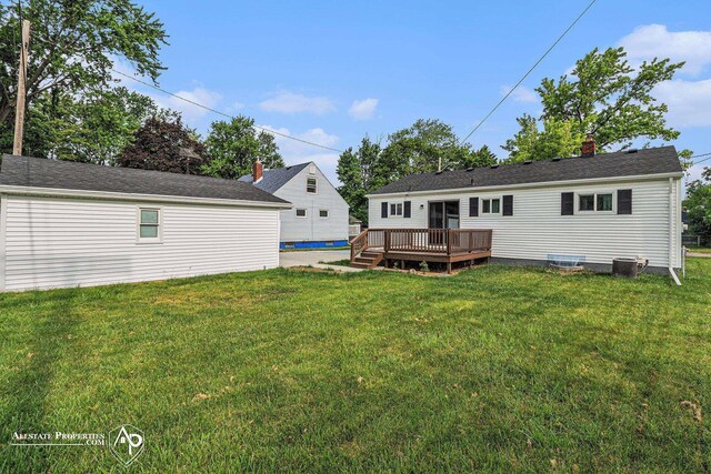 1006 Southlawn Ave, Flint, MI 48507 - rear view of house featuring a deck, a yard, and a chimney