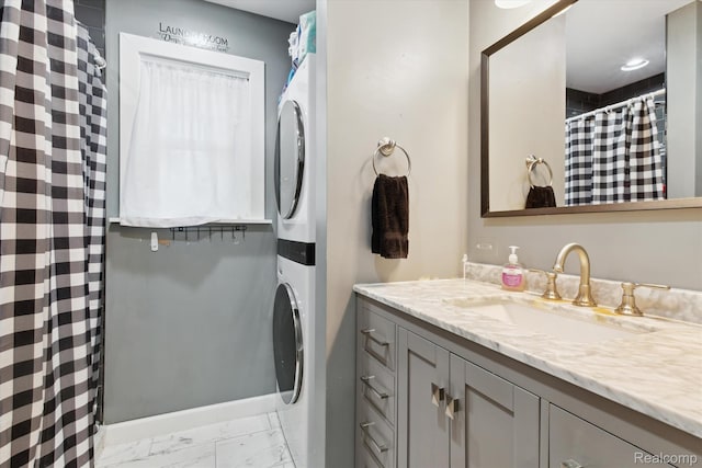 759 Elm St, Allenton, MI 48002 - bathroom featuring stacked washer and clothes dryer, marble finish flooring, and vanity