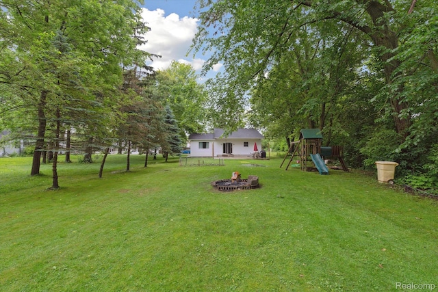 759 Elm St, Allenton, MI 48002 - view of green lawn featuring a playground and a fire pit