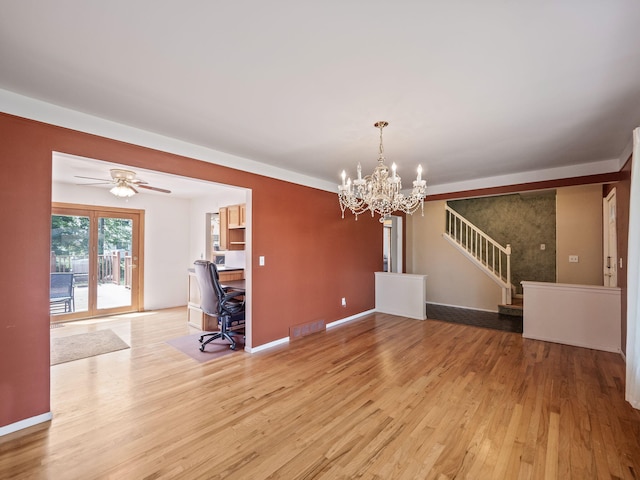 3640 Pall Dr, Warren, MI 48092 - unfurnished living room featuring light wood-style floors, an office area, a chandelier, ceiling fan, and stairs