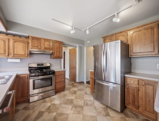 3640 Pall Dr, Warren, MI 48092 - kitchen with appliances with stainless steel finishes, under cabinet range hood, rail lighting, light countertops, and brown cabinetry