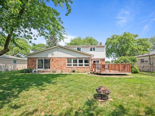 3640 Pall Dr, Warren, MI 48092 - back of house with brick siding, a fire pit, a chimney, and a deck