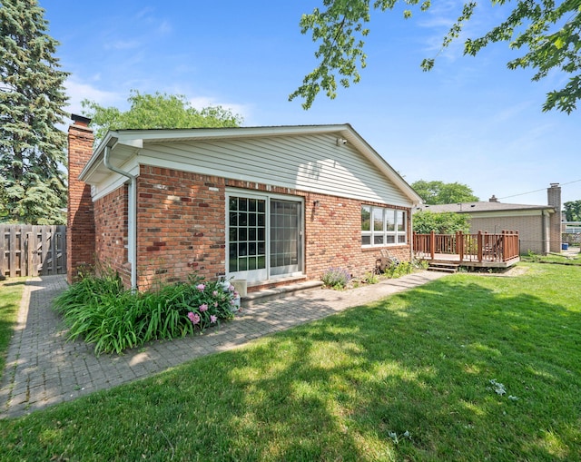 3640 Pall Dr, Warren, MI 48092 - rear view of property featuring a deck, a chimney, and brick siding