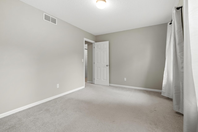 220 Deer Path Ln, Battle Creek, MI 49015 - spare room featuring light carpet and a textured ceiling