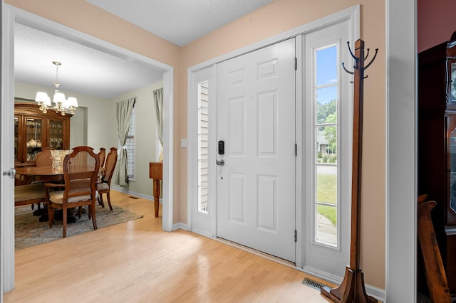 220 Deer Path Ln, Battle Creek, MI 49015 - entryway with light wood finished floors and a chandelier