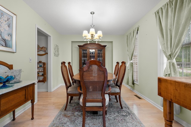 220 Deer Path Ln, Battle Creek, MI 49015 - dining room featuring a chandelier and light wood-style flooring