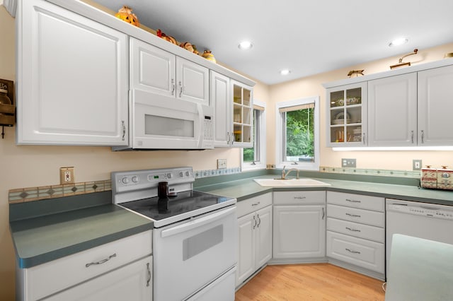 220 Deer Path Ln, Battle Creek, MI 49015 - kitchen with white appliances, white cabinets, recessed lighting, glass insert cabinets, and light wood-type flooring