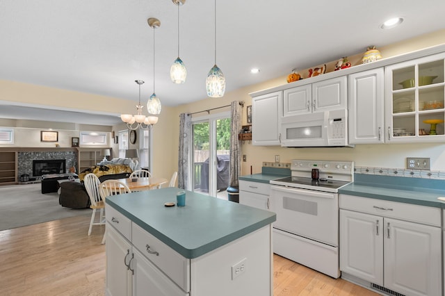 220 Deer Path Ln, Battle Creek, MI 49015 - kitchen featuring white appliances, a kitchen island, dark countertops, light wood-type flooring, and recessed lighting