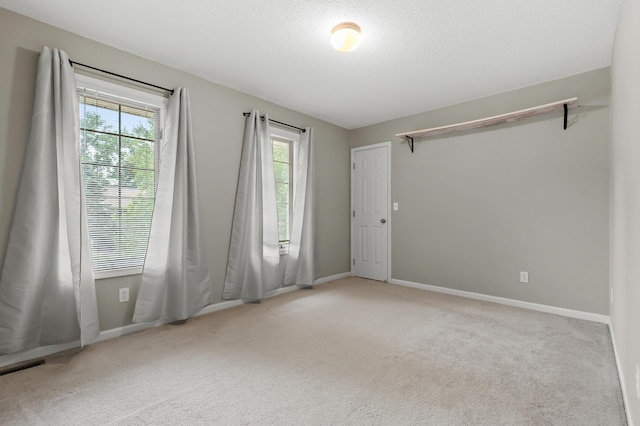 220 Deer Path Ln, Battle Creek, MI 49015 - empty room with healthy amount of natural light and carpet floors
